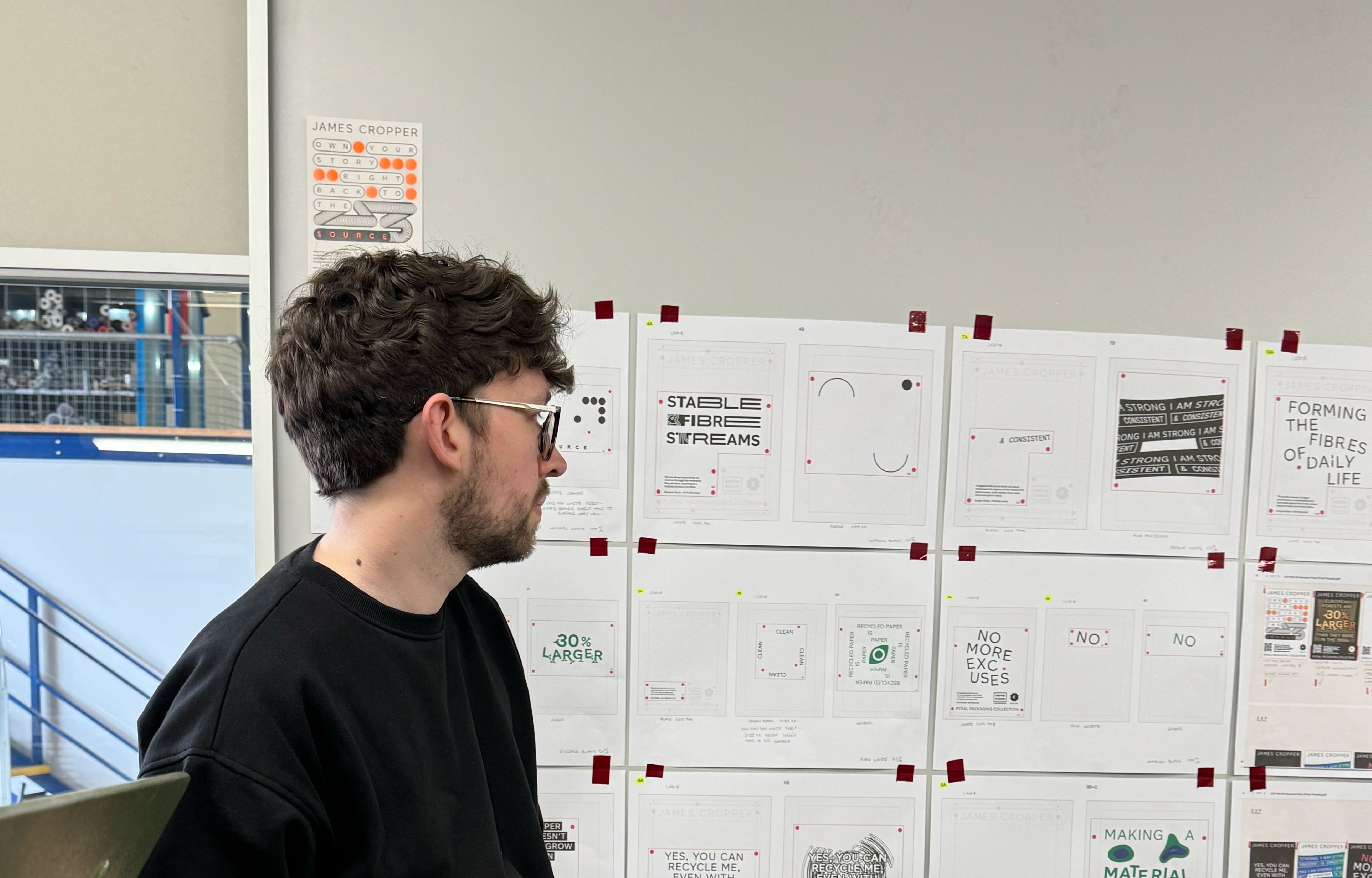 Lead designer Conner looks over printed flat plans on site in the Foilco printing room