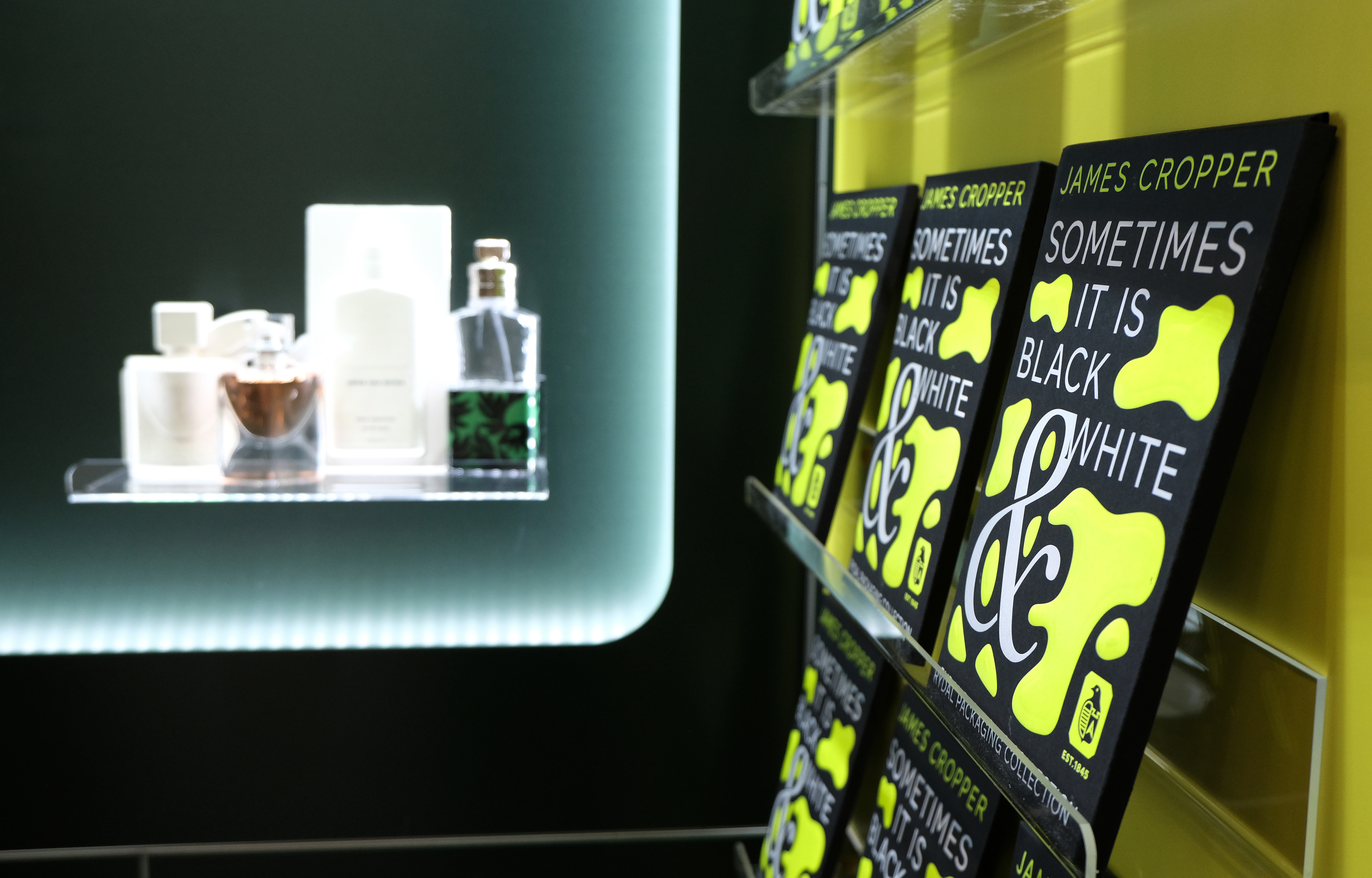 The samples packs sit on the shelf - in the background is packaging for Dries Van Noten and La Vie est Belle