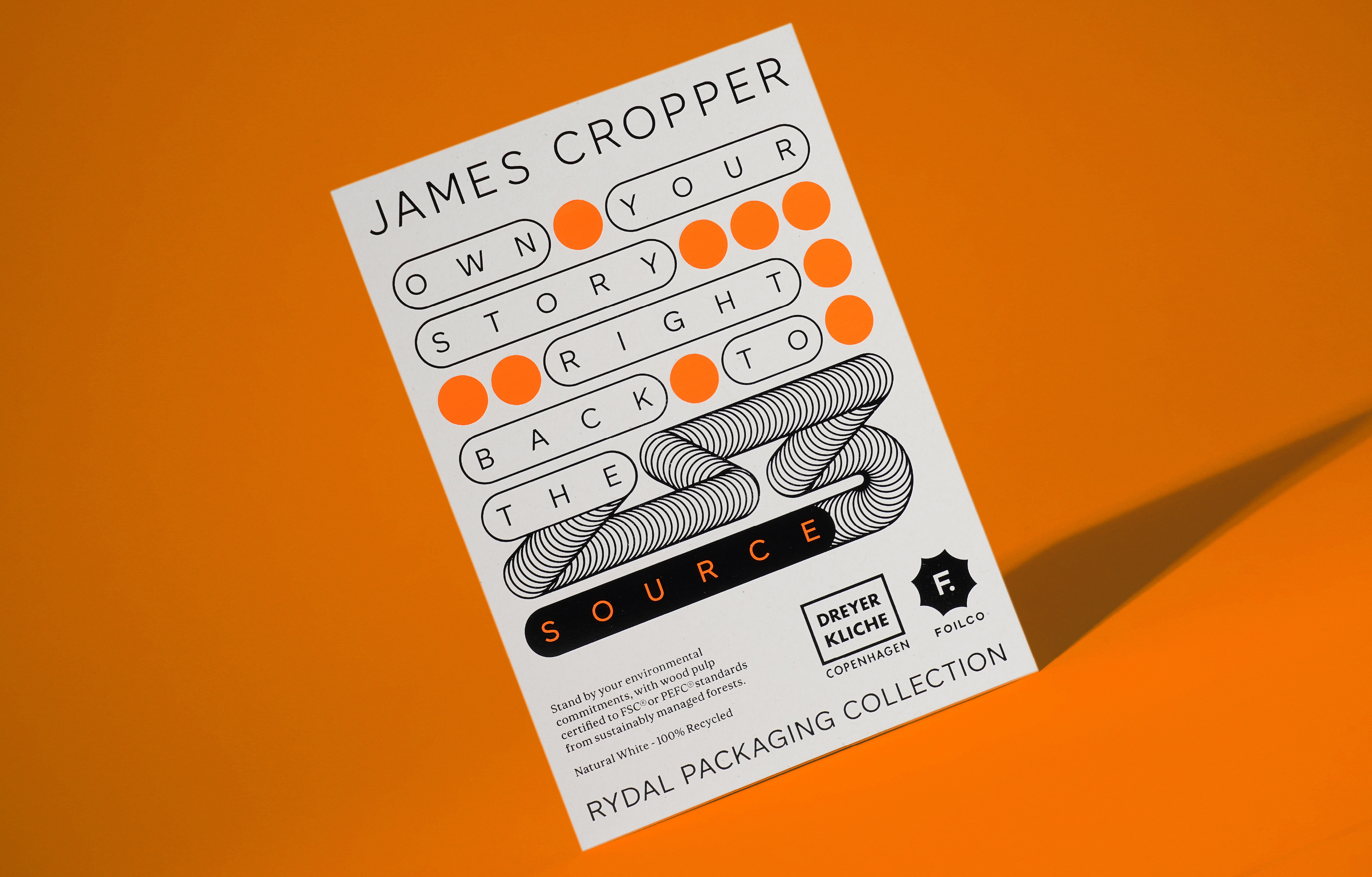 White paper stock on orange background with the statement 'Own your story right back to the source'