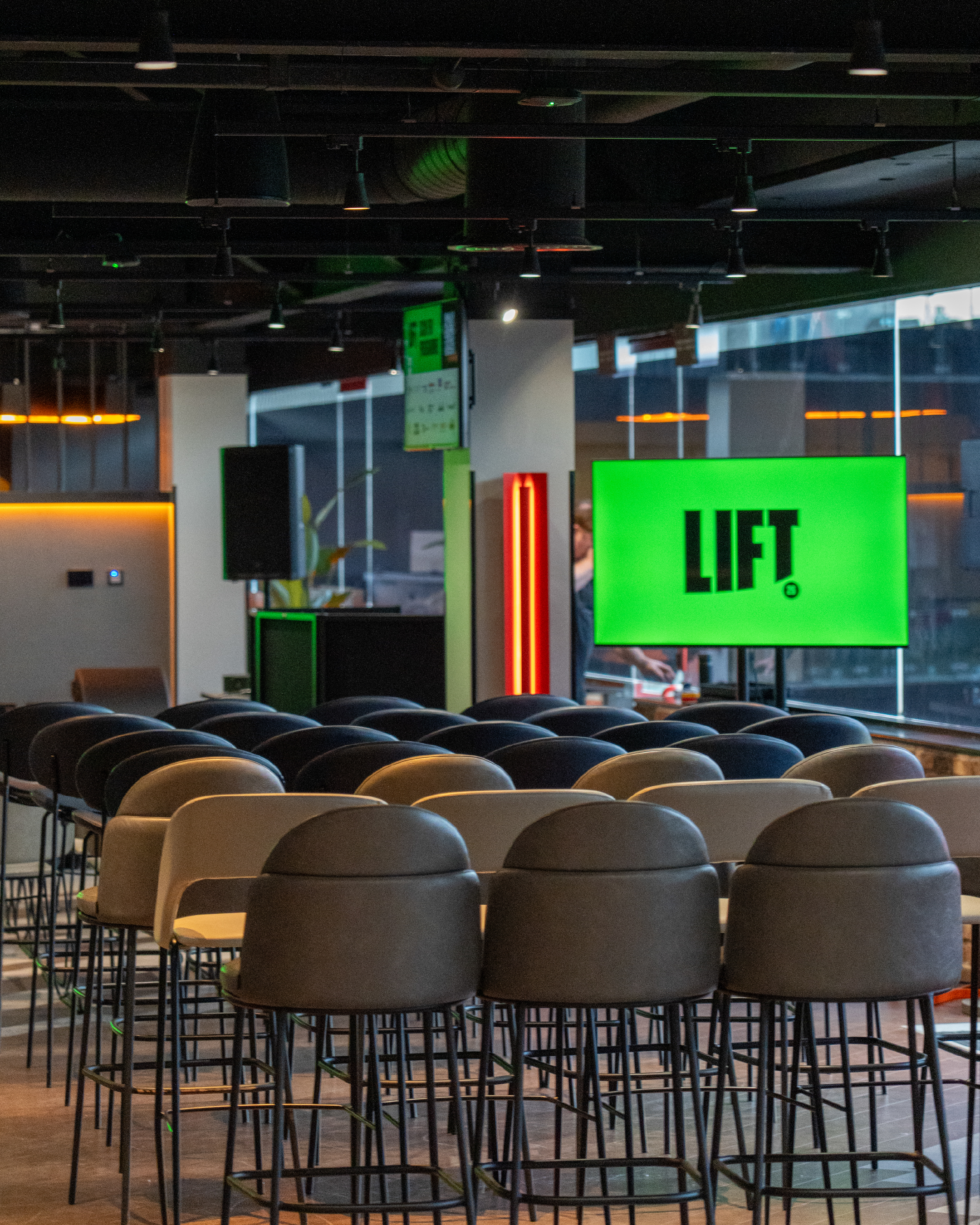 LIFT logo on a screen in front of empty chairs