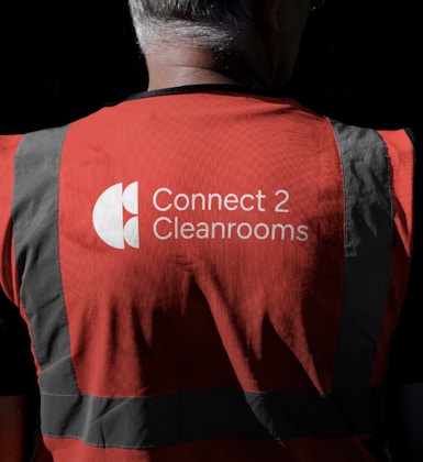 Man wearing Connect 2 Cleanrooms high vis vest