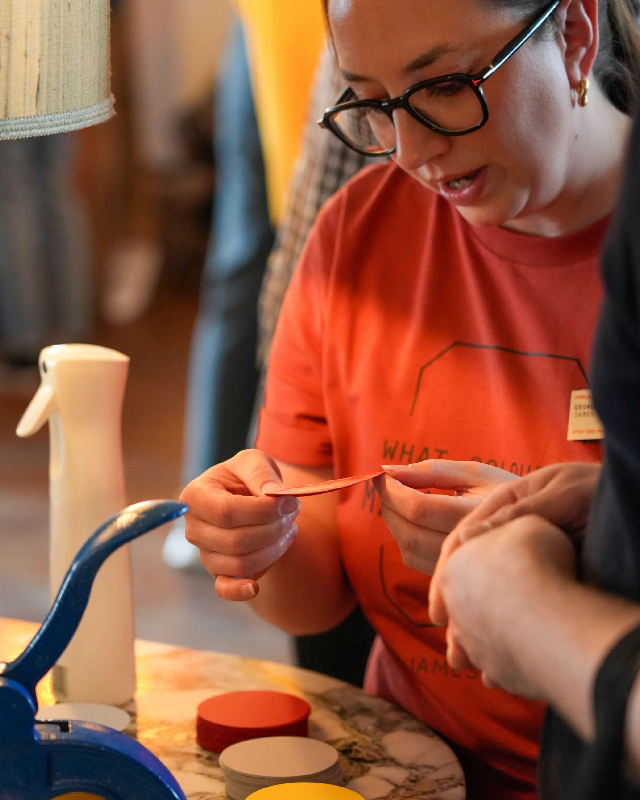 An representative demonstrates the embossing machine to an attendee