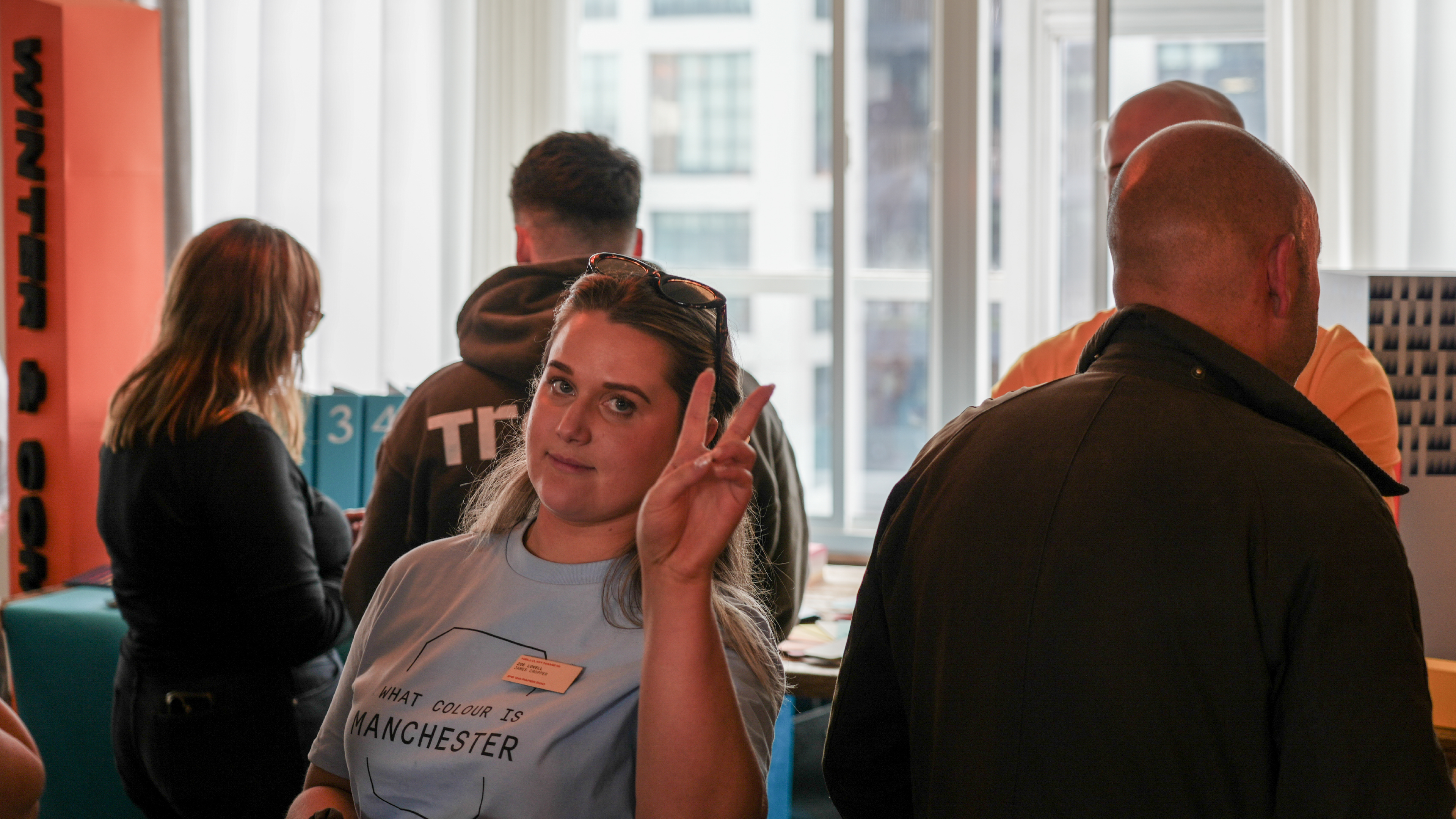Zoe Lovell makes the peace gesture towards camera at the Independent Paper Show event in Manchester