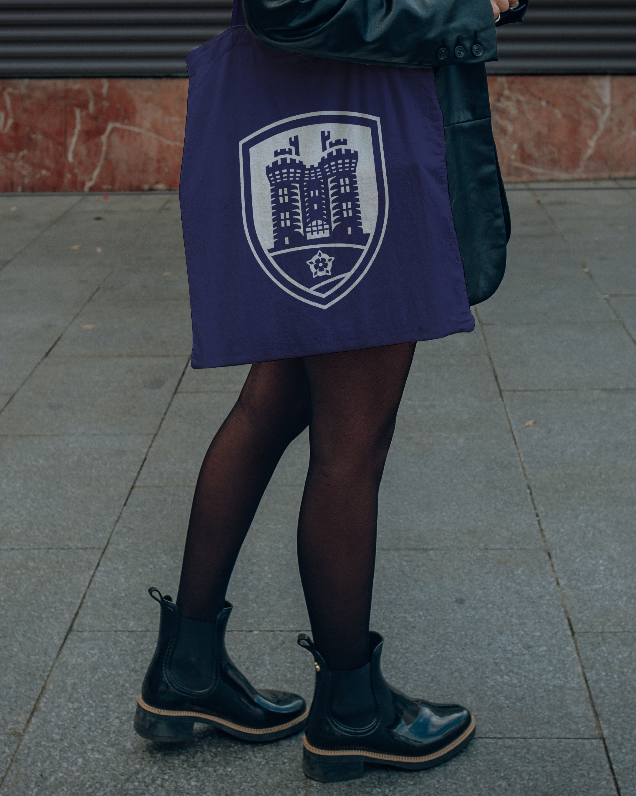 Lancaster High School tote bag being held by a student