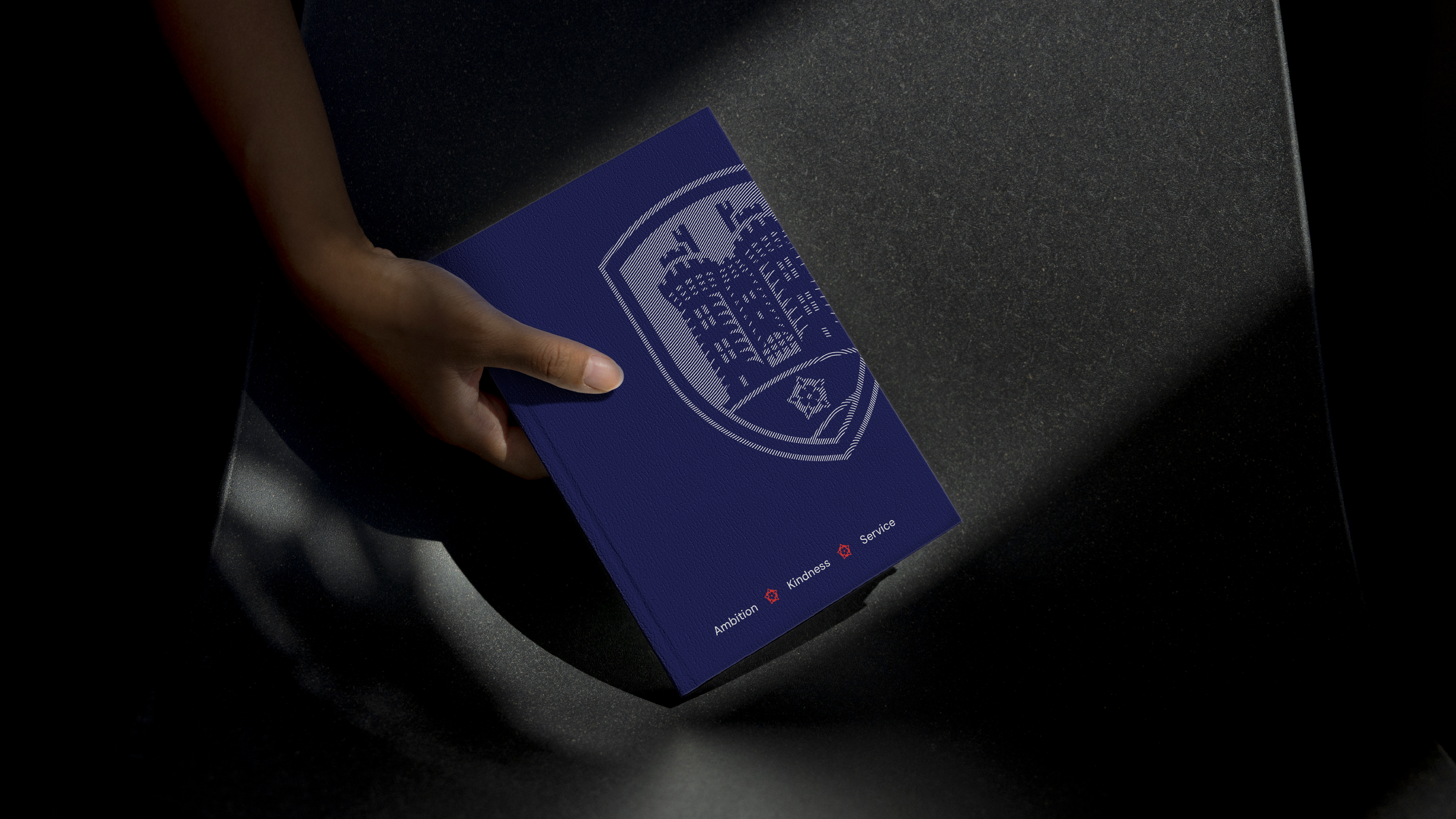 A Lancaster High School branded journal, being held by a student